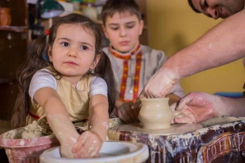 Potter showing how to work with ceramic in pottery studio Stock Photos
