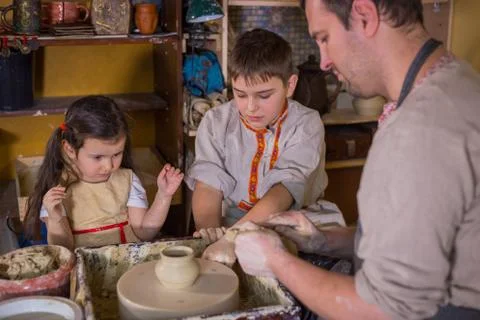 Potter showing how to work with ceramic in pottery studio Stock Photos