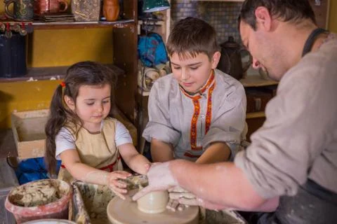 Potter showing how to work with ceramic in pottery studio Stock Photos