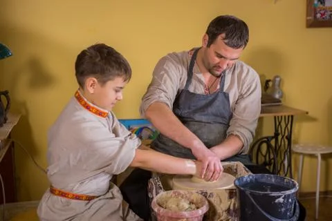 Potter showing how to work with ceramic in pottery studio Stock Photos