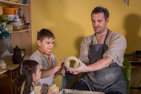 Potter showing how to work with ceramic in pottery studio Stock Photos
