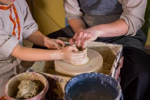 Potter showing how to work with ceramic in pottery studio Stock Photos