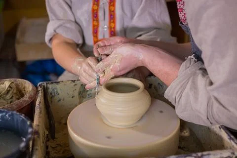 Potter showing how to work with ceramic in pottery studio Stock Photos