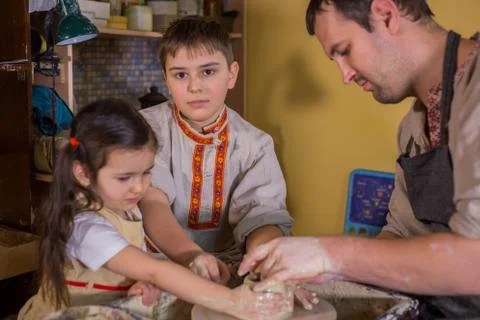 Potter showing how to work with ceramic in pottery studio Stock Photos
