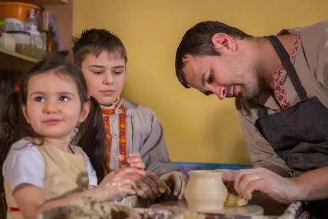 Potter showing how to work with ceramic in pottery studio Stock Photos