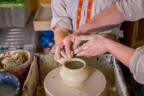 Potter showing how to work with ceramic in pottery studio Stock Photos