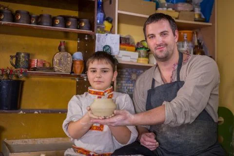 Potter showing how to work with ceramic in pottery studio Stock Photos