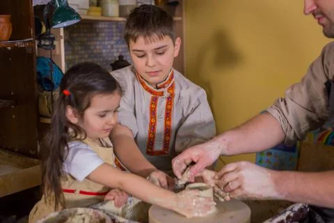 Potter showing how to work with ceramic in pottery studio Stock Photos