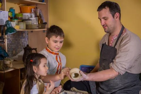 Potter showing how to work with ceramic in pottery studio Stock Photos