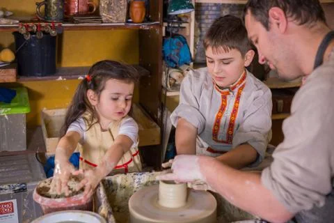 Potter showing how to work with ceramic in pottery studio Stock Photos