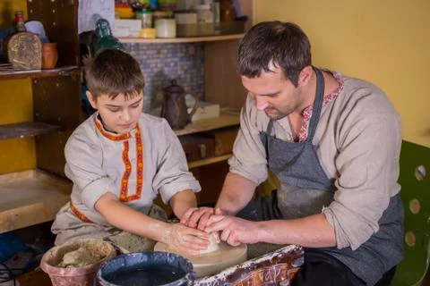 Potter showing how to work with ceramic in pottery studio Stock Photos