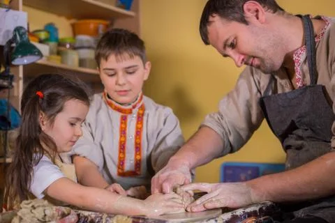 Potter showing how to work with ceramic in pottery studio Stock Photos