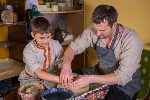 Potter showing how to work with ceramic in pottery studio Stock Photos
