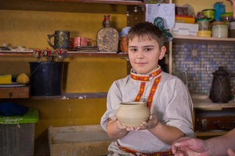 Potter showing how to work with ceramic in pottery studio Stock Photos