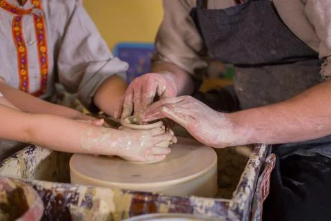 Potter showing how to work with ceramic in pottery studio Stock Photos