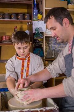 Potter showing how to work with ceramic in pottery studio Stock Photos