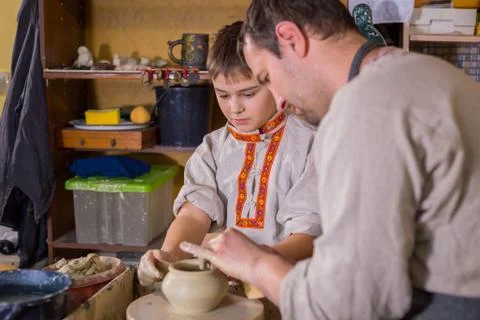 Potter showing how to work with ceramic in pottery studio Stock Photos