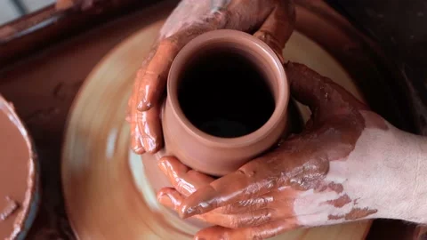The potter smoothes the edges of the jug while works on potter's wheel Stock Footage 201286207