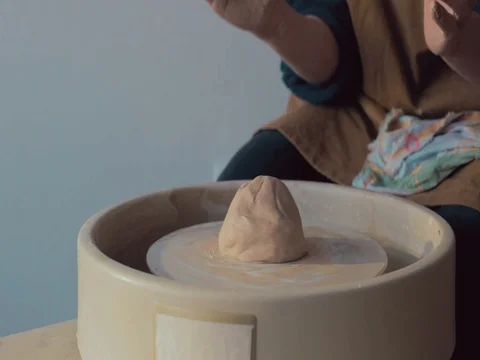 Potter starts to work On His Craft On A Spinning Pottery Wheel Stock Footage 72279192