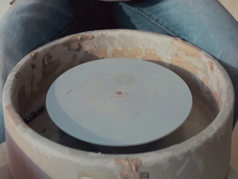 Potter starts to work On His Craft On A Spinning Pottery Wheel Stock-Footage 72279476