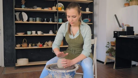 Potter taps a clay cup. Making ceramic products from white clay Stock Footage 119543496