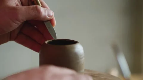 The potter uses a knife to remove excess clay. utensils for the tea ceremony Stock Footage 145534460