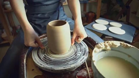 A potter using a potter's wheel making a vase Stock Footage 278311099