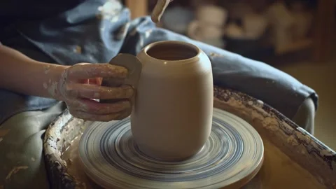 A potter using a potter's wheel making a vase Stock Footage 278311565