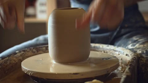 A potter using a potter's wheel making a vase Stock Footage 278311590