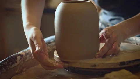 A potter using a potter's wheel making a vase Stock Footage 278311619
