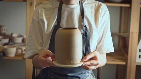 A potter using a potter's wheel making a vase Stock Footage 278311622