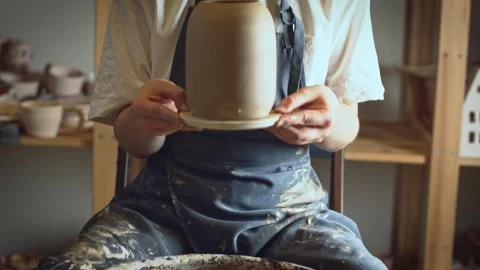 A potter using a potter's wheel making a vase Stock Footage 278311625