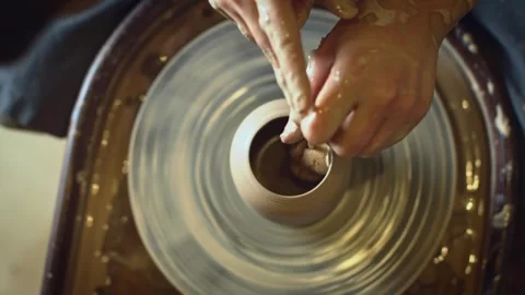 A potter using a potter's wheel making a vase Stock Footage 278311640