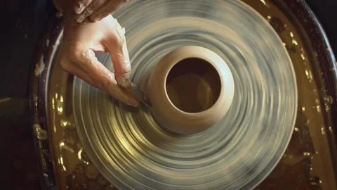 A potter using a potter's wheel making a vase Stock Footage 278311647