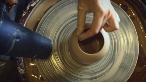 A potter using a potter's wheel making a vase Stock Footage 278311657