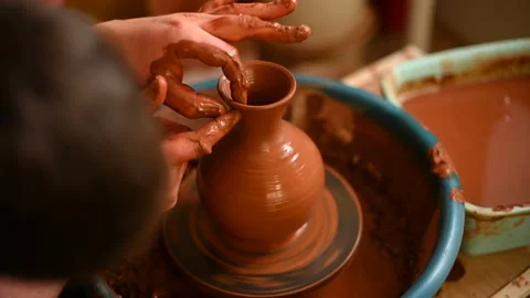 Potter at work on circle wheel in workshop Stock Footage 150309776