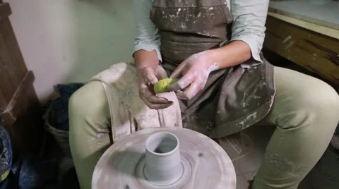 Potter at work creating clay on turning wheel Stock Footage 61932949