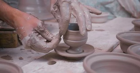 Potter at work making ceramic cup on from white clay. Stock Photos