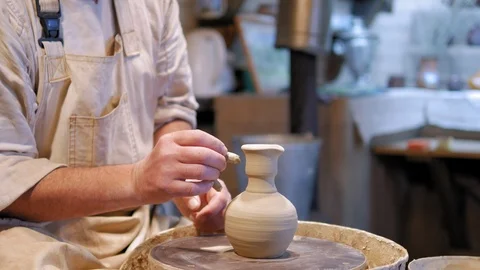 Potter at work. Potter making ceramic pot on the pottery wheel Stock Footage 90465759