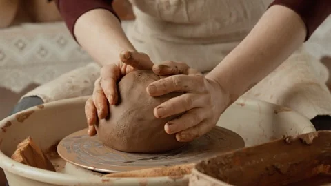 Potter at work. Potter's hands covered with clay making beautiful vase. Video stock 248325308