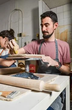 Potter working clay in pottery workshop, shaping and molding a piece of art Stock Photos