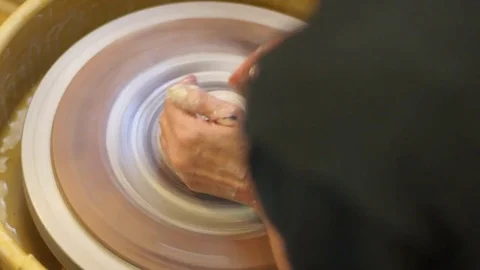 Potter working clay on wheel OTS Stock Footage 71939872