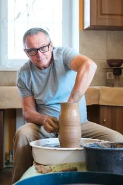 Potter working with clay in workshop. Stock Photos
