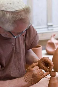 Potter working with his hands. Stock Photos