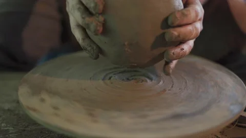 Potter working on potters wheel making ceramic pot from clay in pottery workshop Stock Footage 158968588