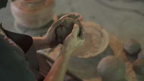 Potter working on potters wheel making ceramic pot from clay in pottery workshop Stock Footage 158968758