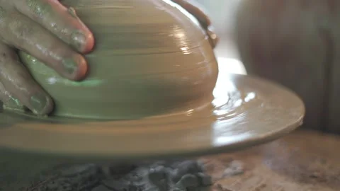 Potter working on potters wheel making ceramic pot from clay in pottery workshop Stock Footage 158969100