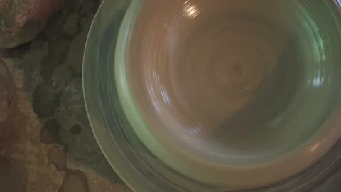 Potter working on potters wheel making ceramic pot from clay in pottery workshop Stock Footage 158969606