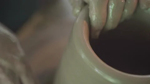 Potter working on potters wheel making ceramic pot from clay in pottery workshop Stock Footage 158969977