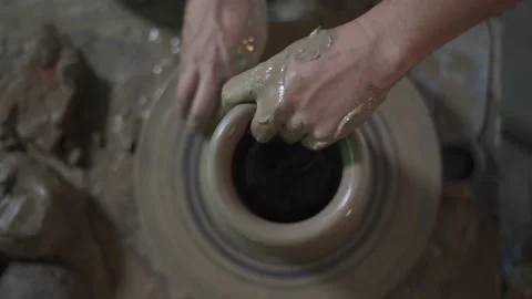 Potter working on potters wheel making ceramic pot from clay in pottery workshop Stock Footage 158970229